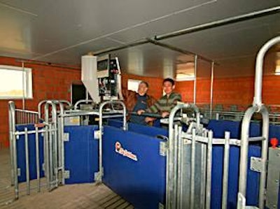 Roger Parfitt, (left), with Liu Yang, check a Callmatic installation at a recently upgraded pig farm in Asia.