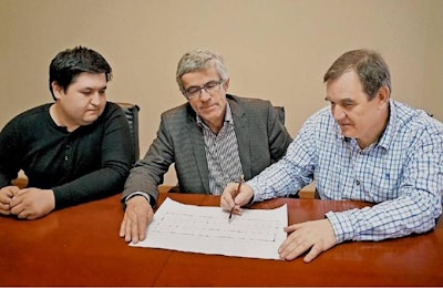 Imkon Group and Pas Reform officials go over plans for a new hatchery to be built in Uzbekistan. | Pas Reform