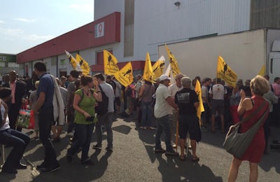 Protestors from the farmer’s union, Confederation Paysanne (Peasant Confederation), demonstrate in favor of relief for French dairy farmers at SPACE. | Jackie Roembke