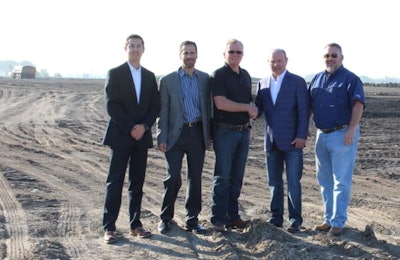 Walt Shafer, project leader for Lincoln Premium Poultry and Larry Campbell, vice president of sales for Marel Poultry shake hands on the largest single order to date for Marel. Also pictured are Ray Collison, Matt Brass and Scott Thompson. | Photo courtesy of Marel