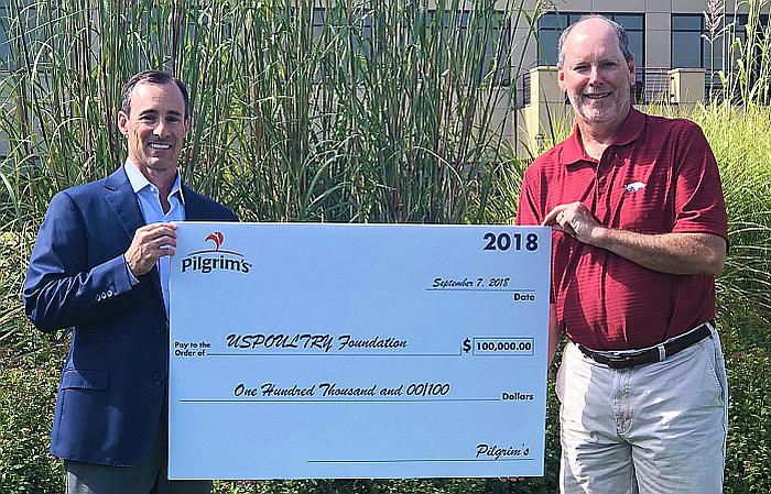 Jayson Penn, president of Pilgrim&rsquo;s USA, presents a ceremonial check to Jerry Moye, Hendrix Genetics, and current USPOULTRY Foundation chairman. | Photo courtesy of USPOULTRY