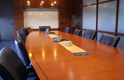 Meeting room with chairs and a white board.