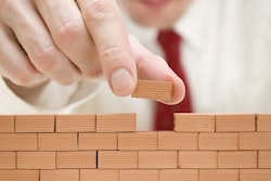 businessman building a wall