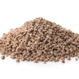 Pile of compound feed pellets isolated on white