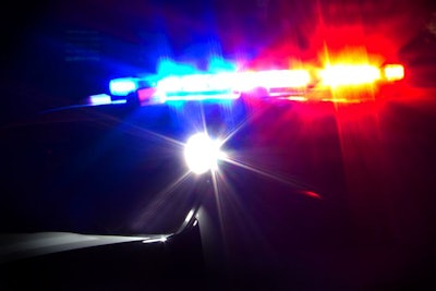 Red and Blue Emergency Lights Flashing on Police Car at Night