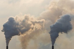 Industrial smoke stacks pumping out pollution in the atmosphere