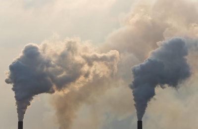 Industrial smoke stacks pumping out pollution in the atmosphere