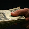 holding-money-one-dollar