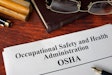 Occupational Safety and Health Administration OSHA and a book.