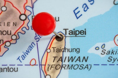 Close-up of a red pushpin in a map of Taipei, Taiwan.
