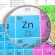 Zinc – Element of Mendeleev Periodic table magnified with magnifying glass