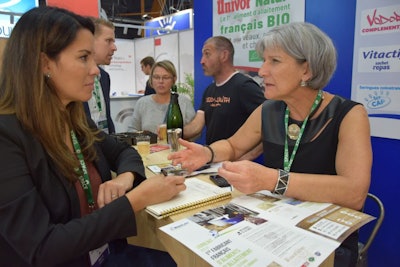 Feed Strategy editor Jackie Roembke visits with Univor marketing manager Isabelle Mourot at the Bonilait booth at SPACE. (Yanne Boloh)