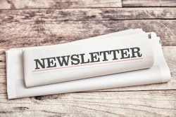 Newsletter newspaper with information and news lies on a wooden