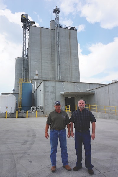 Mar-Jac Poultry AL LLC’s Spruce Pine feed mill manager, Jimmy Potter (left), and live production manager Keith Martin stand outside the poultry integrator’s new $33 million feed mill. (Jackie Roembke)