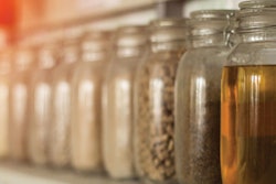 Exhibition samples with rapeseed oil, animal feed and cereals, close-up, canola oil