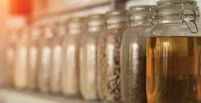 Exhibition samples with rapeseed oil, animal feed and cereals, close-up, canola oil