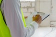Foreman Builder, Engineer Or Inspector In Green Safety Vest Refl