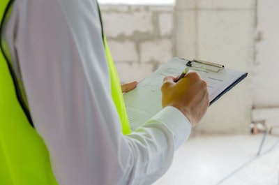 Foreman Builder, Engineer Or Inspector In Green Safety Vest Refl