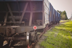 Train Beside Old Grain Elevators On Sunset
