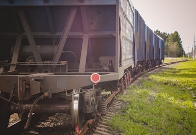 Train Beside Old Grain Elevators On Sunset