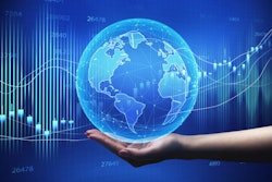 Global Economy. Female Hand Holding World Globe Over Blue Backgr