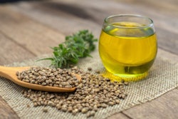 Cbd Hemp Oil In A Glass Bottle.hemp Seeds In A Wooden Spoon The