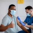 African American Man In Antiviral Mask Gesturing Thumb Up During