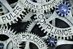 Macro photo of tooth wheels with COMPLIANCE, REGULATIONS, STANDARDS, POLICIES and RULES words imprinted on metal surface