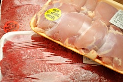 Packaged meat at the market; boneless chicken thighs and beef cube steaks..** Note: Shallow depth of field