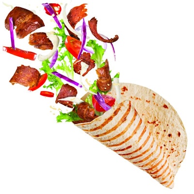 Close-up of kebab sandwich with flying ingredients. Freeze motion.