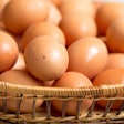 Brown farmers cage-free chicken eggs in basket, close up