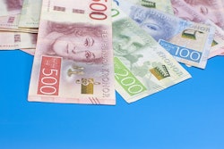 Swedish krona banknotes of different denominations on a blue background