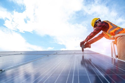 Solar Panel Technician With Drill Installing And Maintenance Sol