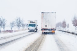 Freight Transportation Truck On The Road In Snow Storm Blizzard,