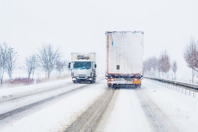 Freight Transportation Truck On The Road In Snow Storm Blizzard,