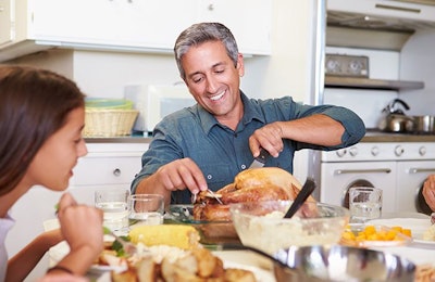 Dad Carving Roast Chicken At Table