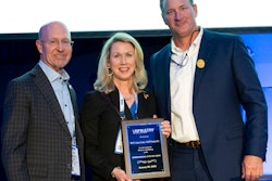 Greg Watt and Nancy Batio from WATT Global Media accept the long-time exhibitor plaque from Mikell Fries (right), Claxton Poultry Farms and USPOULTRY chair.