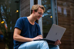 Happy Employee Outside With Laptop
