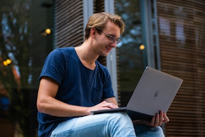 Happy Employee Outside With Laptop