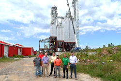 Representatives from Gerber & Sons, Inc., The Commercial & Savings Bank, and USDA Rural Development stand near the new feed mill site under construction in Baltic, Ohio.