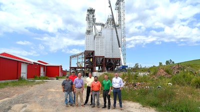 Representatives from Gerber & Sons, Inc., The Commercial & Savings Bank, and USDA Rural Development stand near the new feed mill site under construction in Baltic, Ohio.