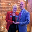 USPOULTRY Executive Vice President Gwen Venable presents the Lamplighter Award to Greg Watt, president and CEO of WATT Global Media.