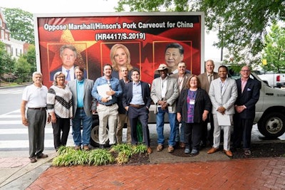 Members of the Organization for Competitive Markets pose with a billboard truck that encourages federal legislators to oppose the EATS Act. The truck is again making the rounds as part of an anti-EATS Act campaign.