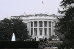 White House south facade with American flag, fountain, and surrounding trees
