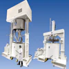 Large industrial mixing equipment with white Ross machinery and worker in safety gear