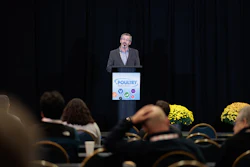 Speaker presenting at Poultry conference with logo and audience in foreground