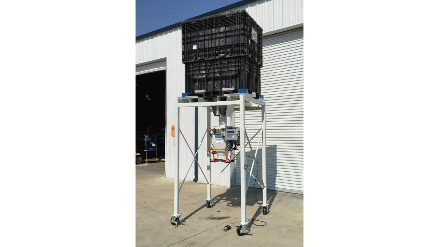 Industrial equipment stand with black plastic crate mounted on mobile white metal frame