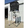Industrial equipment stand with black plastic crate mounted on mobile white metal frame