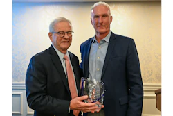 Joel Newman (left) is presented with the AFIA Distinguished Service Award by Dan Meagher, AFIA 2025-26 Board Chair.