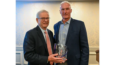 Joel Newman (left) is presented with the AFIA Distinguished Service Award by Dan Meagher, AFIA 2025-26 Board Chair.